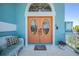 Inviting entryway with an ornate double door, a welcome mat, and a comfortable bench at 6186 Seaside Dr, New Port Richey, FL 34652