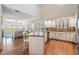 Bright kitchen featuring granite countertops, white cabinets, and stainless steel appliances with an open floor plan at 6186 Seaside Dr, New Port Richey, FL 34652