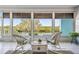 Relaxing screened lanai with wicker furniture overlooking a scenic water view at 6186 Seaside Dr, New Port Richey, FL 34652