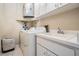 Functional laundry area with white washer, dryer, sink, and ample cabinet space at 6186 Seaside Dr, New Port Richey, FL 34652
