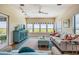 Cozy living room filled with natural light, featuring a modern cabinet and comfortable seating arrangement at 6186 Seaside Dr, New Port Richey, FL 34652