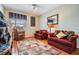 Sitting room features hardwood floors, two windows, sofas, and a decorative area rug at 6186 Seaside Dr, New Port Richey, FL 34652