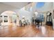 Grand living room featuring a piano, high ceilings, and hardwood floors for a refined ambiance at 6186 Seaside Dr, New Port Richey, FL 34652