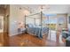 Spacious main bedroom with hardwood floors, a four-poster bed, and a balcony at 6186 Seaside Dr, New Port Richey, FL 34652