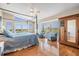 A comfortable main bedroom with a four-poster bed, wood floors, and abundant natural light at 6186 Seaside Dr, New Port Richey, FL 34652