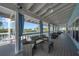 Covered outdoor seating area with wicker furniture and views of the waterfront at 6186 Seaside Dr, New Port Richey, FL 34652