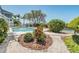 Backyard pool area with lush landscaping and a glimpse of the waterfront at 6186 Seaside Dr, New Port Richey, FL 34652