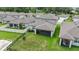 Aerial view of the property showing the home, lawn, screened in porch, and surrounding neighborhood at 6248 Bradford Woods Dr, Zephyrhills, FL 33542