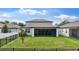 The backyard features a lush green lawn and a screened in porch for outdoor relaxation at 6248 Bradford Woods Dr, Zephyrhills, FL 33542