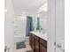 Bathroom with vanity, shower-tub combination, and neutral-colored tiling at 6248 Bradford Woods Dr, Zephyrhills, FL 33542