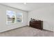 Bedroom with light walls, neutral carpet, two large windows, and a dark dresser at 6248 Bradford Woods Dr, Zephyrhills, FL 33542