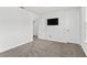 Large bedroom features neutral walls, carpet, and multiple doors for closet and bathroom access at 6248 Bradford Woods Dr, Zephyrhills, FL 33542