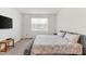 Well-lit bedroom featuring a king-sized bed, soft carpet, and a flat-screen television at 6248 Bradford Woods Dr, Zephyrhills, FL 33542