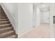 Light and bright entryway with tiled floor and staircase at 6248 Bradford Woods Dr, Zephyrhills, FL 33542