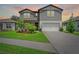 Beautiful two-story home with a well-manicured lawn and an attached two-car garage at 6248 Bradford Woods Dr, Zephyrhills, FL 33542