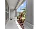 View of the front porch and landscaping with lush, colorful foliage at 6248 Bradford Woods Dr, Zephyrhills, FL 33542