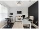 Functional home office with desk setup, multiple monitors, and exercise equipment at 6248 Bradford Woods Dr, Zephyrhills, FL 33542