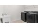 Laundry room complete with new appliances and utility sink at 6248 Bradford Woods Dr, Zephyrhills, FL 33542