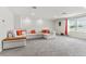 Spacious living room with large sectional sofa and ample natural light at 6248 Bradford Woods Dr, Zephyrhills, FL 33542