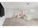 Bright, open-concept living room with a sectional sofa and modern fixtures at 6248 Bradford Woods Dr, Zephyrhills, FL 33542