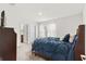 Main bedroom with dark wood furniture and ensuite bathroom access at 6248 Bradford Woods Dr, Zephyrhills, FL 33542