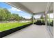 Covered outdoor patio offers views of the landscaped backyard and neighborhood at 6248 Bradford Woods Dr, Zephyrhills, FL 33542