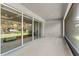 Spacious covered patio area with large sliding glass doors and outdoor shades at 6248 Bradford Woods Dr, Zephyrhills, FL 33542