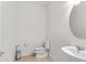 Bright powder room featuring a sink, toilet, and modern fixtures at 6248 Bradford Woods Dr, Zephyrhills, FL 33542