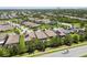 Aerial view of homes with well-manicured lawns, mature trees, screened-in pools, and solar panels at 6467 Seasound Dr, Apollo Beach, FL 33572