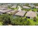 Aerial view of houses with screened patios, and pools surrounded by mature trees and lush landscaping at 6467 Seasound Dr, Apollo Beach, FL 33572