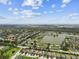Stunning aerial view of a lakeside community, revealing mature landscaping and peaceful, tree-lined streets at 6467 Seasound Dr, Apollo Beach, FL 33572