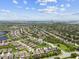 Expansive aerial view of a residential neighborhood with mature trees, community ponds, and a clear blue sky at 6467 Seasound Dr, Apollo Beach, FL 33572