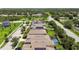 Aerial view of the neighborhood homes featuring solar panels, mature trees, screened pools, and play equipment at 6467 Seasound Dr, Apollo Beach, FL 33572