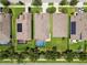 Overhead view of neighborhood homes with screened-in pools, solar panels, and nicely manicured lawns at 6467 Seasound Dr, Apollo Beach, FL 33572