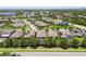 Aerial view of a residential neighborhood with mature trees, manicured lawns, screened-in pools, and solar panels at 6467 Seasound Dr, Apollo Beach, FL 33572