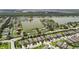 High angle aerial view of a residential area with a lake, featuring well-maintained homes and neatly lined streets at 6467 Seasound Dr, Apollo Beach, FL 33572