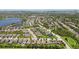 Scenic aerial view of a residential community near a lake with tree-lined streets and landscaped lawns at 6467 Seasound Dr, Apollo Beach, FL 33572