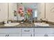 A bathroom showcasing a dual sink vanity, granite countertop, and large mirror at 6467 Seasound Dr, Apollo Beach, FL 33572