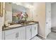 Elegant bathroom with dual sinks, granite countertops, and a glass-enclosed shower at 6467 Seasound Dr, Apollo Beach, FL 33572