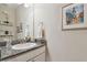 Bathroom featuring granite countertops, white cabinets, and updated fixtures at 6467 Seasound Dr, Apollo Beach, FL 33572