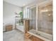 Bathroom featuring soaking tub and glass enclosed shower with shelving at 6467 Seasound Dr, Apollo Beach, FL 33572
