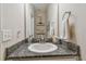 Close-up of bathroom with granite countertops, white cabinets, and modern fixtures at 6467 Seasound Dr, Apollo Beach, FL 33572
