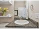 Bright bathroom featuring granite countertops, white cabinets, and modern fixtures at 6467 Seasound Dr, Apollo Beach, FL 33572