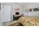 Cozy bedroom featuring yellow floral bedding, neutral walls, and decoratively-framed photos at 6467 Seasound Dr, Apollo Beach, FL 33572