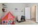A cozy bedroom showcasing a play tent, crib and light-filled ambiance at 6467 Seasound Dr, Apollo Beach, FL 33572