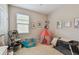 Bright bedroom featuring a stroller, crib, play tent and a ball pit at 6467 Seasound Dr, Apollo Beach, FL 33572