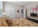 Bright bedroom with a yellow floral bedspread, neutral walls, and double door closet at 6467 Seasound Dr, Apollo Beach, FL 33572