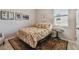 Cozy bedroom featuring a floral comforter, decorative pillows, and a patterned rug at 6467 Seasound Dr, Apollo Beach, FL 33572
