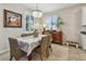 Bright dining room with decorative accents, window shutters, and an elegant chandelier at 6467 Seasound Dr, Apollo Beach, FL 33572