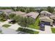 Well-maintained home featuring lush green grass, mature trees, and a spacious driveway, plus a black SUV parked at 6467 Seasound Dr, Apollo Beach, FL 33572